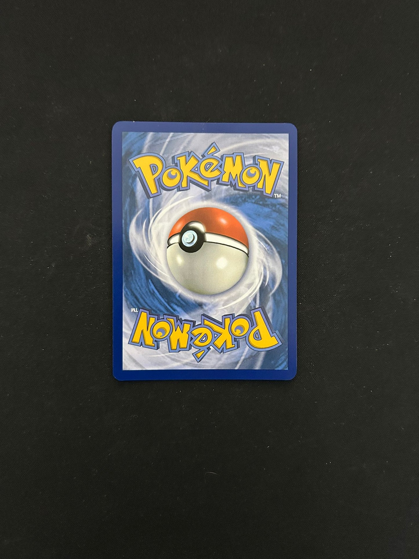 Back side of a Pokémon TCG card, featuring the classic blue background with a swirling pattern and a centered Poké Ball design. The word 'Pokémon' is displayed in bold yellow lettering at the top and bottom, maintaining the iconic look of official Pokémon trading cards.
