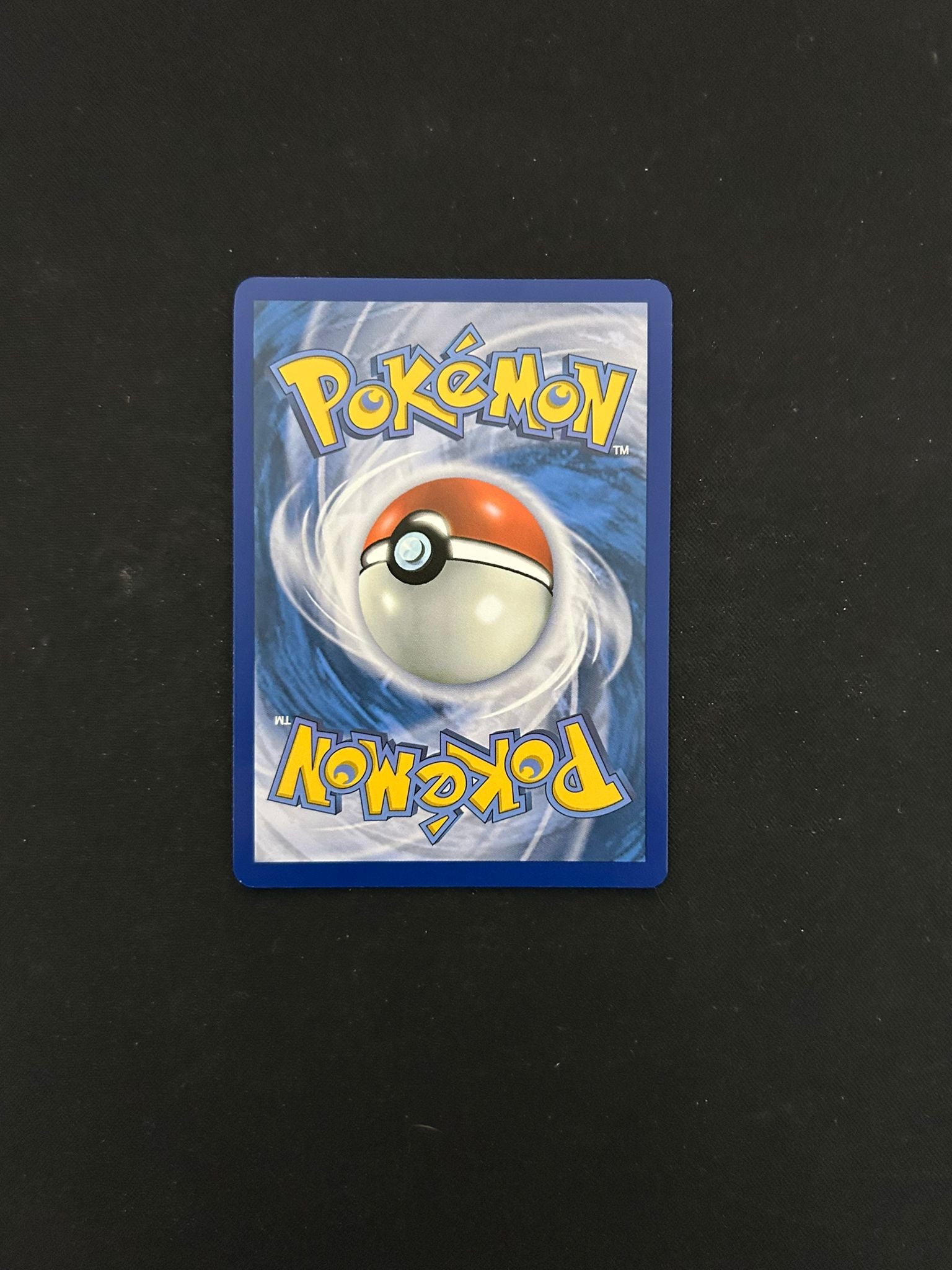 Back side of a Pokémon TCG card, featuring the classic blue background with a swirling pattern and a centered Poké Ball design. The word 'Pokémon' is displayed in bold yellow lettering at the top and bottom, maintaining the iconic look of official Pokémon trading cards.