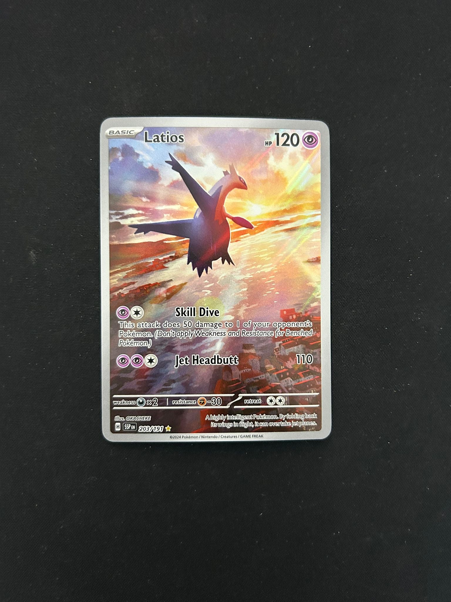 Latios #203 Pokémon TCG card from Scarlet & Violet: Surging Sparks, featuring stunning Illustration Rare artwork of Latios soaring through the sky with a dynamic background. The card displays its attacks, energy cost, and set details with a beautiful holographic finish.