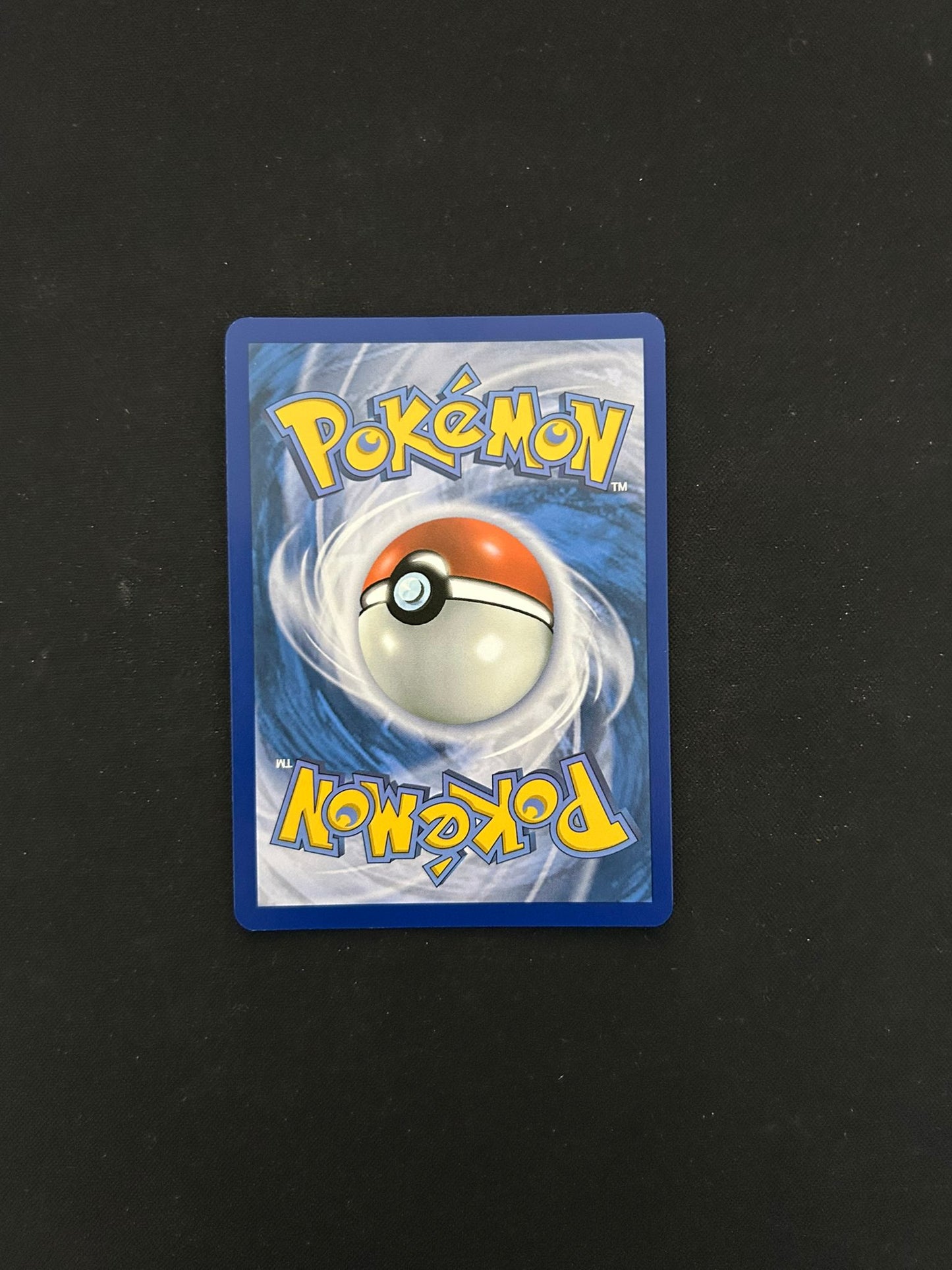 Back side of a Pokémon TCG card, featuring the classic blue background with a swirling pattern and a centered Poké Ball design. The word 'Pokémon' is displayed in bold yellow lettering at the top and bottom, maintaining the iconic look of official Pokémon trading cards.