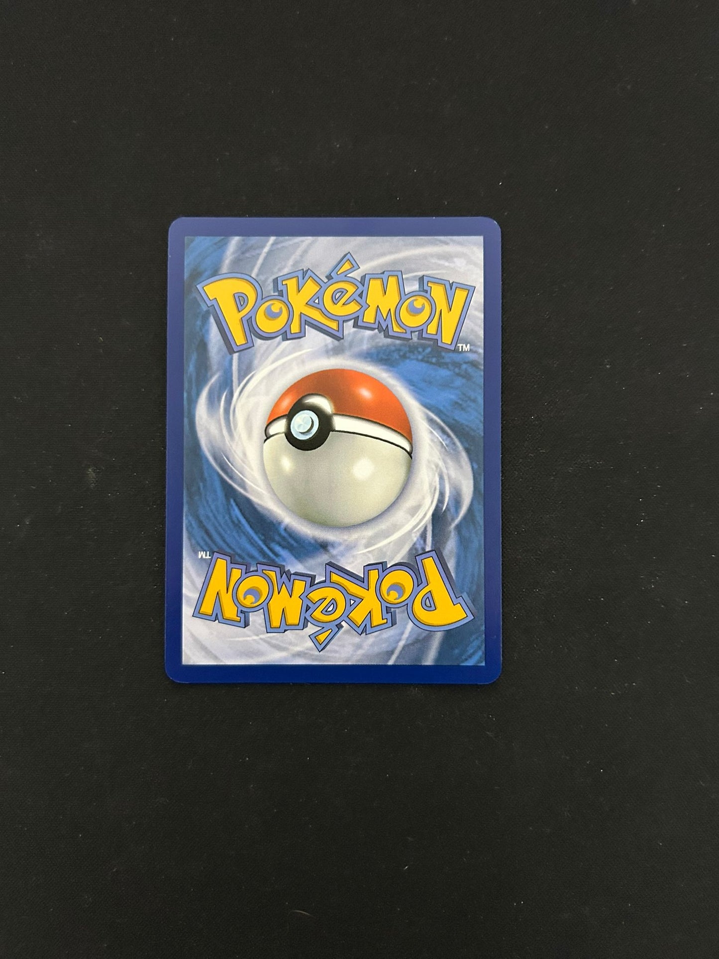 Back side of a Pokémon TCG card, featuring the classic blue background with a swirling pattern and a centered Poké Ball design. The word 'Pokémon' is displayed in bold yellow lettering at the top and bottom, maintaining the signature look of official Pokémon trading cards.