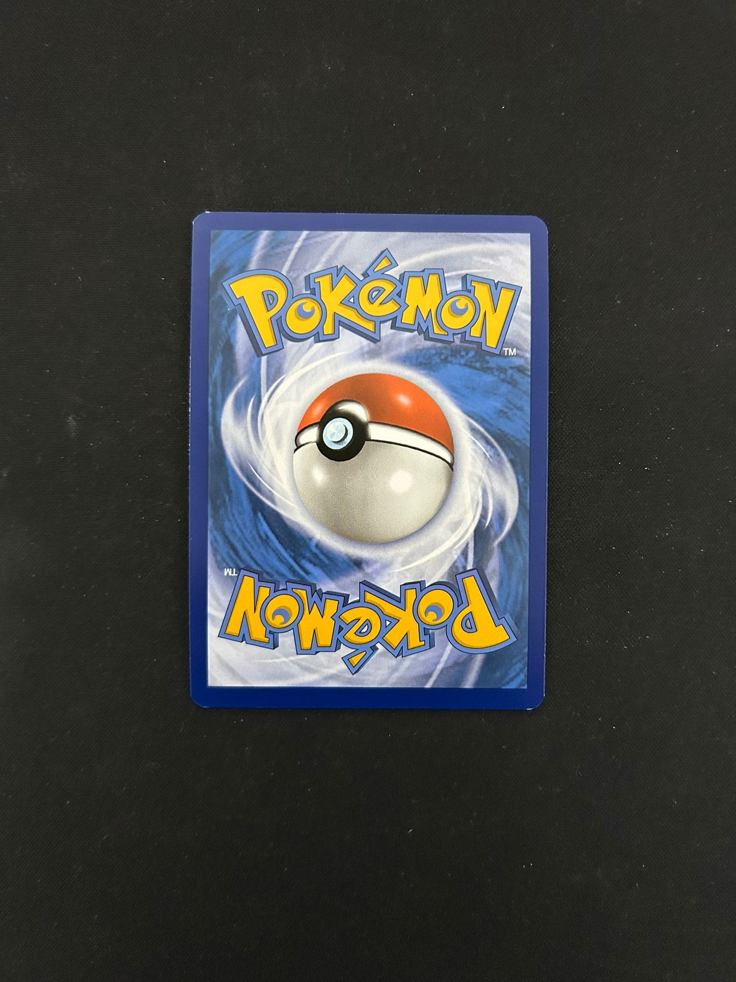 Back side of a Pokémon TCG card, featuring the iconic blue background with a swirling pattern and a centered Poké Ball design. The word 'Pokémon' is displayed in bold yellow lettering at the top and bottom, maintaining the classic look of official Pokémon trading cards.